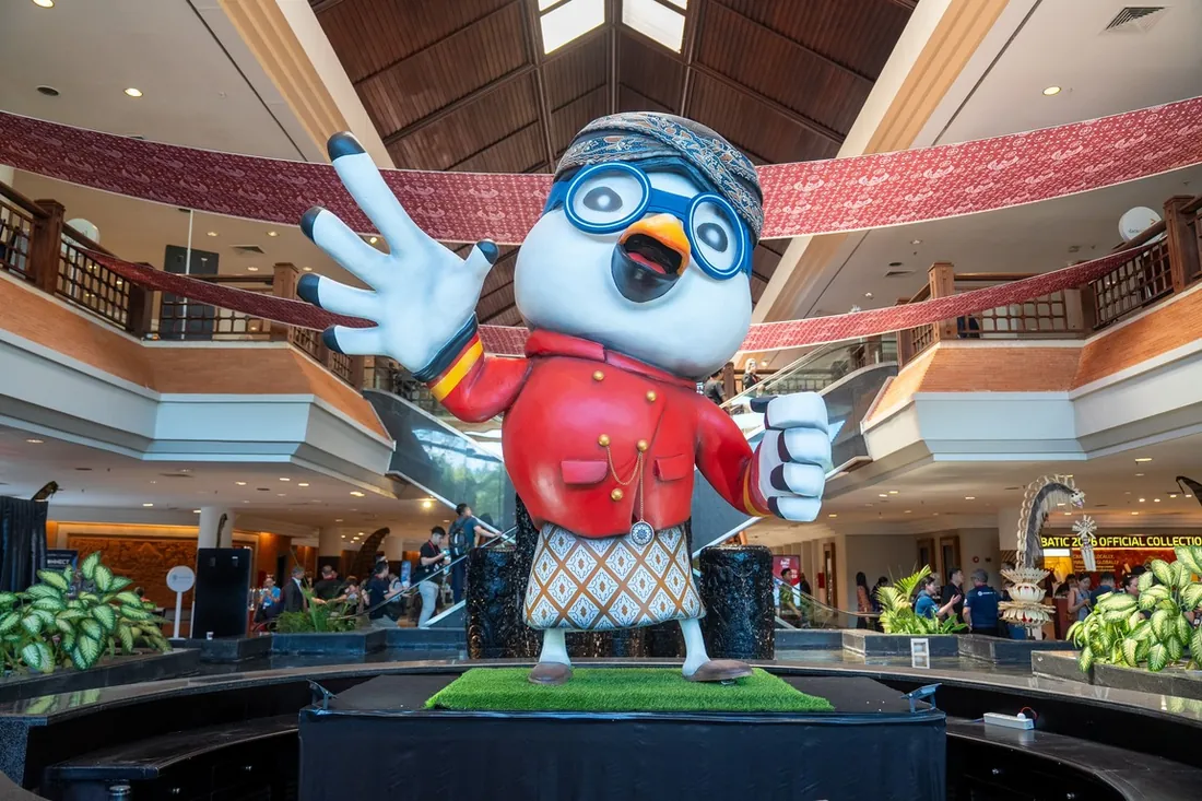 BATIC 2026 batik-dressed mascot welcoming guests in the lobby