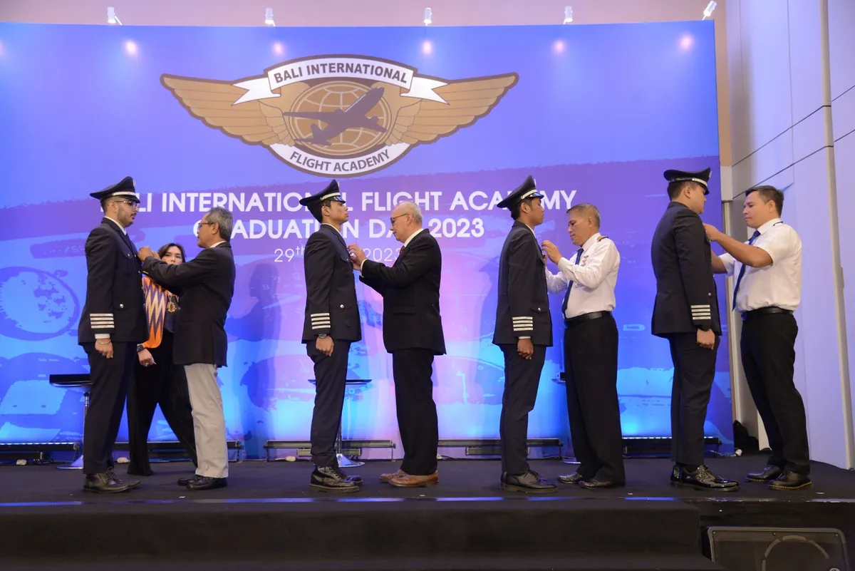 Wings pinning ceremony on stage at Bali International Flight Academy Graduation Day 2023
